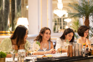 Les Amis Barcelona event — women connecting at elegant cocktail dinner