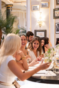 Les Amis Barcelona dinner event — women laughing at curated social gathering