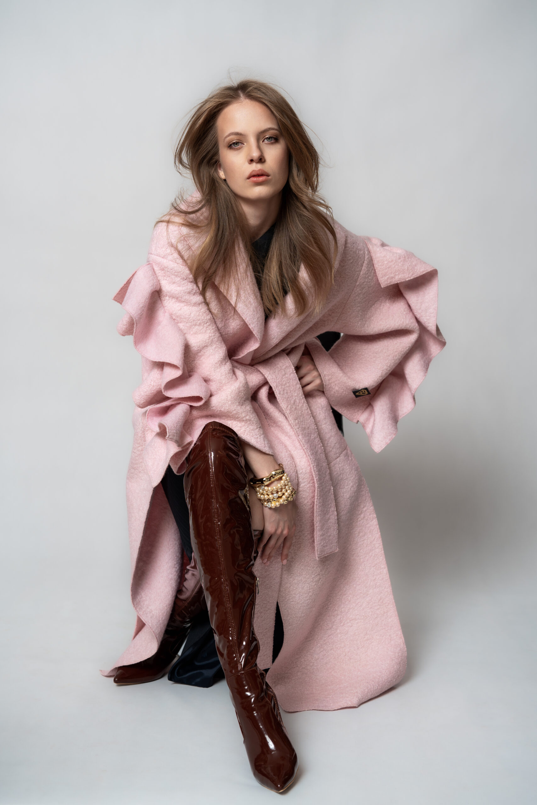 Editorial shot of a pink ruffled coat by Ewa Zbaraszewska