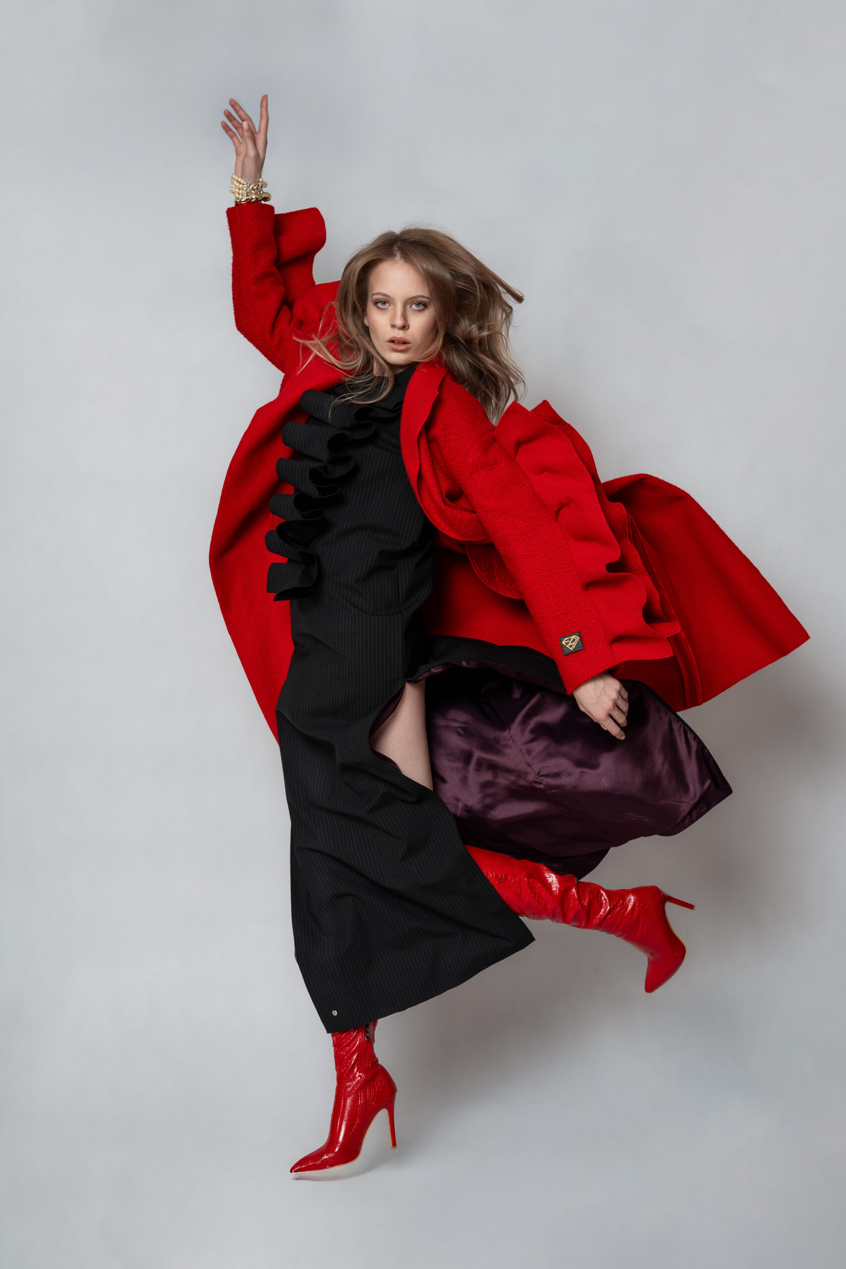 Editorial shot of a red wool coat by Ewa Zbaraszewska